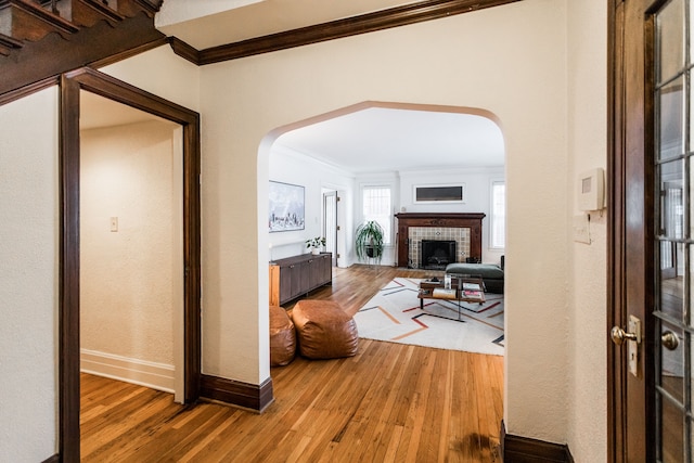 corridor featuring hardwood / wood-style flooring and ornamental molding