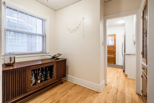 hallway featuring a healthy amount of sunlight and light wood-type flooring