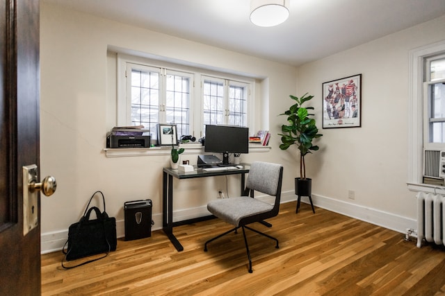 office space featuring light hardwood / wood-style flooring and radiator heating unit