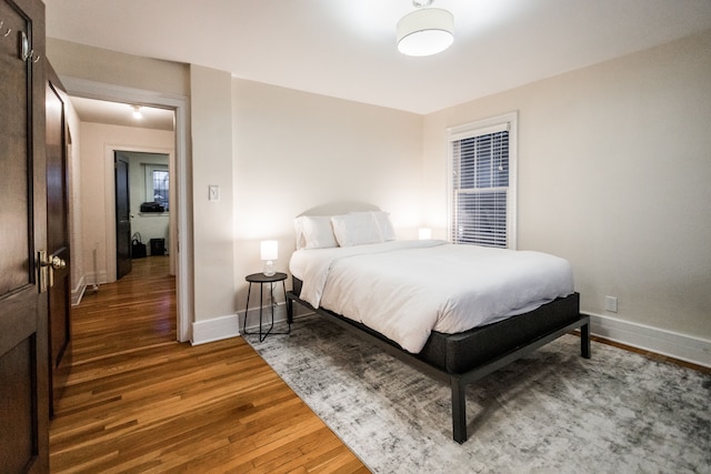 bedroom with dark wood-type flooring