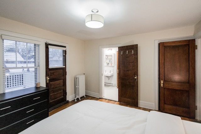 bedroom featuring dark wood-type flooring and radiator