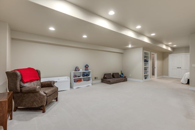 sitting room featuring light carpet