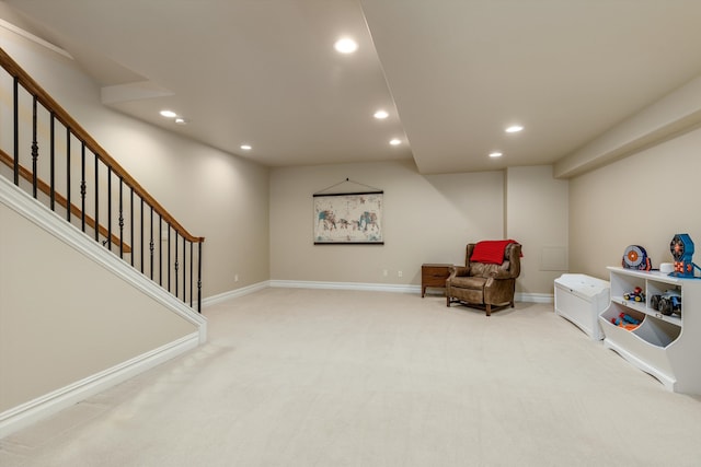 sitting room featuring light colored carpet