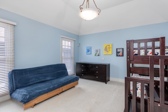 carpeted bedroom with lofted ceiling