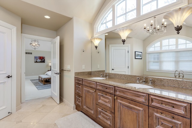 bathroom featuring tile patterned flooring, vanity, vaulted ceiling, and an inviting chandelier