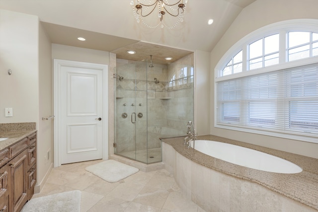 bathroom with lofted ceiling, vanity, a shower with shower door, and a chandelier