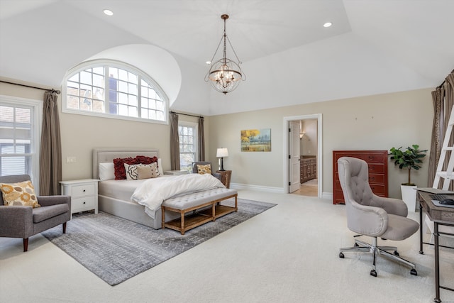 carpeted bedroom featuring vaulted ceiling, ensuite bathroom, and a notable chandelier