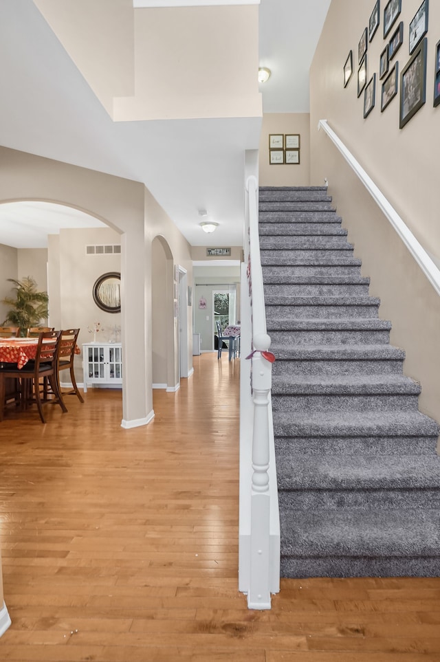 stairs with hardwood / wood-style floors