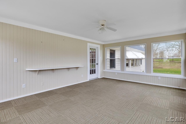 unfurnished sunroom featuring ceiling fan