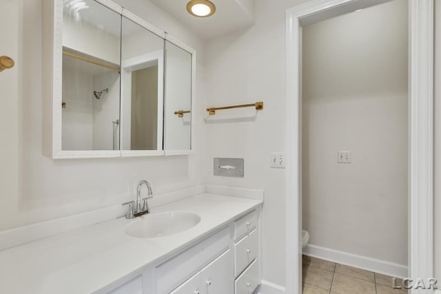 bathroom featuring vanity, toilet, and tile patterned flooring