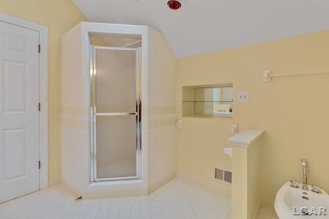 bathroom with a bidet, a shower with shower door, tile patterned floors, and lofted ceiling