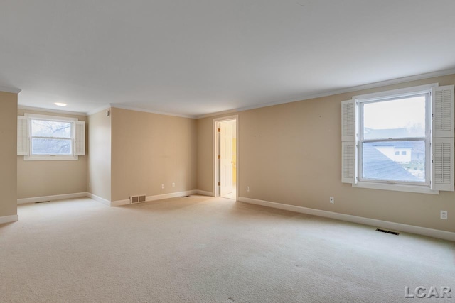 carpeted empty room featuring ornamental molding