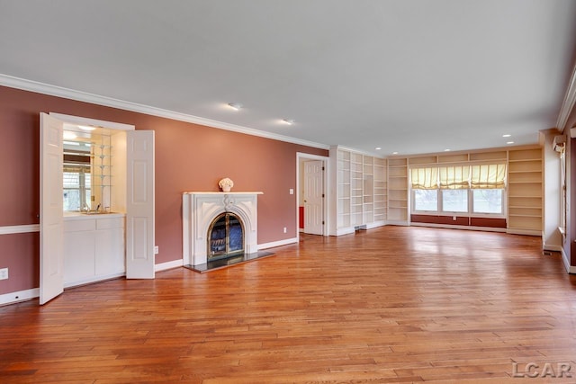 unfurnished living room with crown molding, a high end fireplace, and plenty of natural light