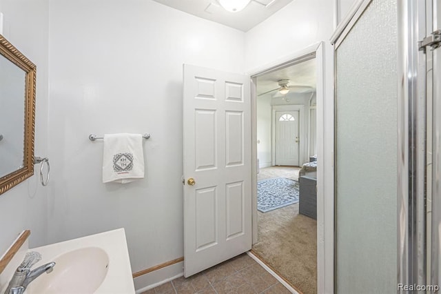 bathroom with ceiling fan, tile patterned flooring, and sink