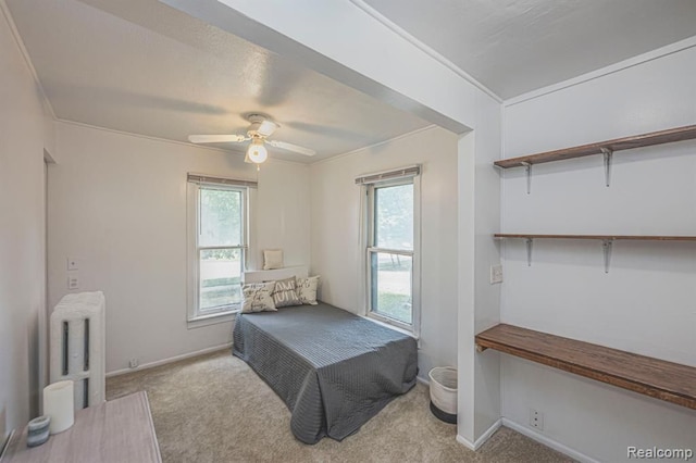 carpeted bedroom featuring ornamental molding, radiator, and multiple windows