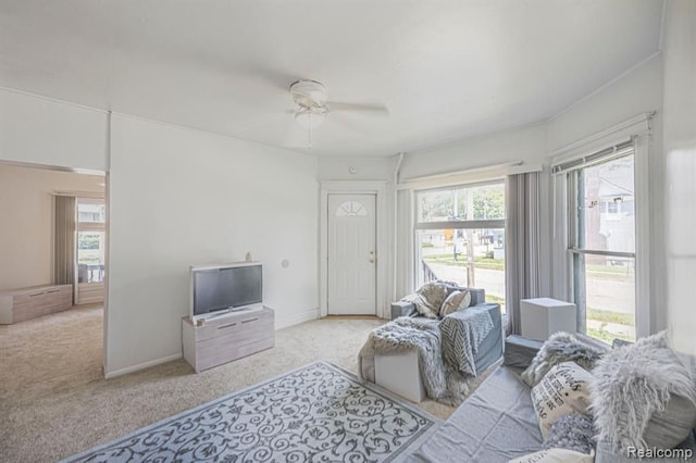 living room with ceiling fan and light colored carpet