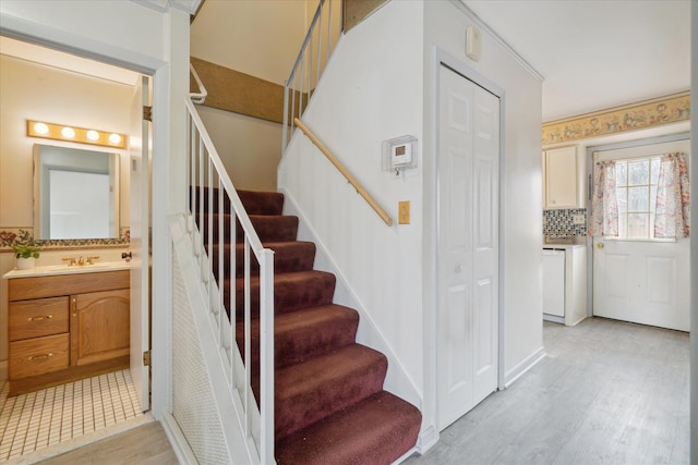 staircase with sink and hardwood / wood-style floors