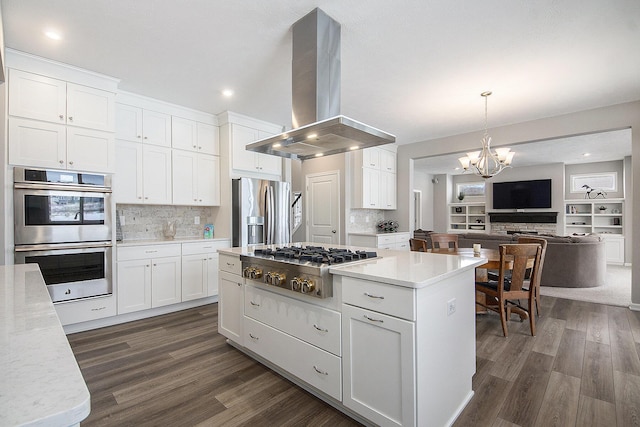 kitchen with white cabinetry, decorative light fixtures, dark hardwood / wood-style floors, island exhaust hood, and stainless steel appliances