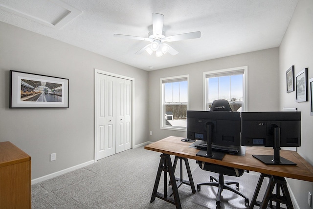 office space featuring carpet floors, a textured ceiling, and ceiling fan