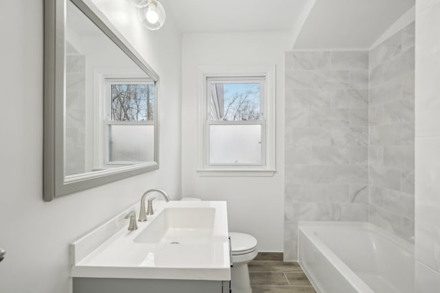 full bathroom with vanity, toilet, and washtub / shower combination