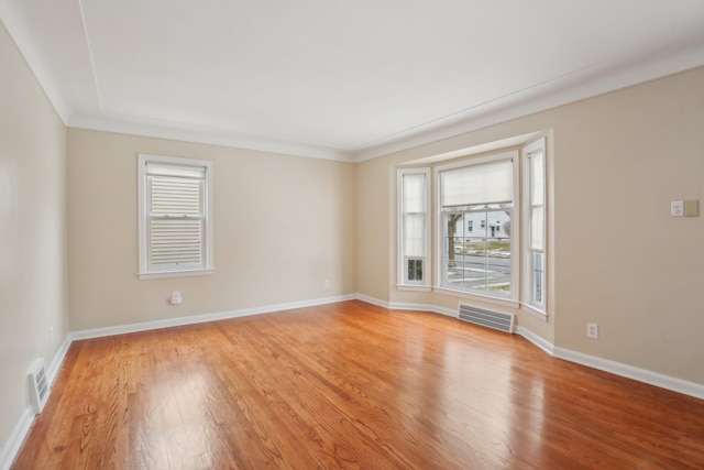 spare room featuring light hardwood / wood-style flooring