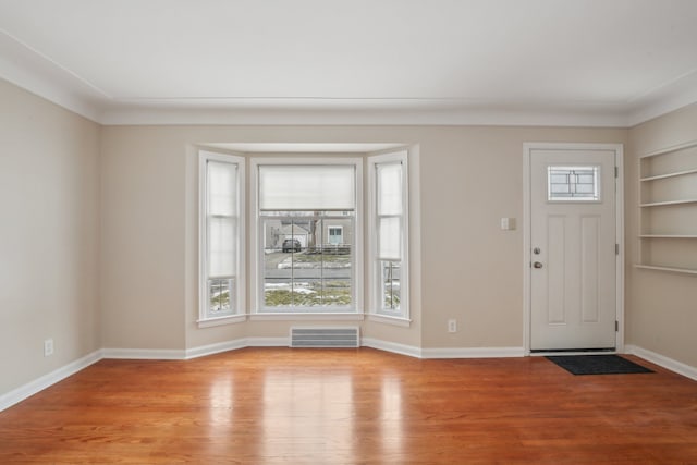 foyer entrance with light hardwood / wood-style flooring and a wealth of natural light