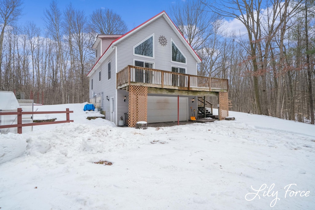 exterior space with a wooden deck and a garage