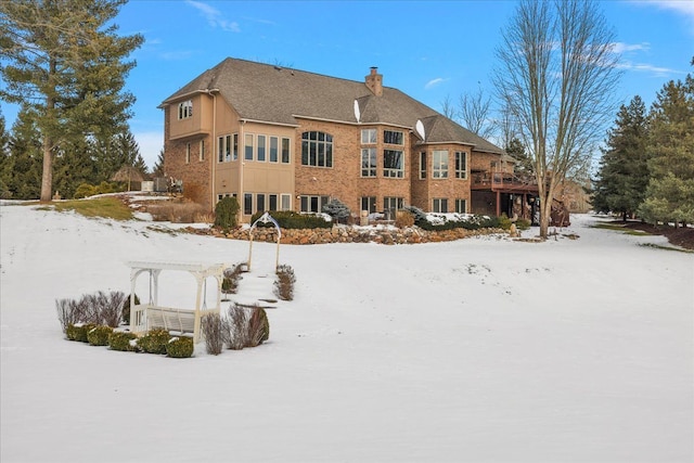 snow covered house featuring a pergola