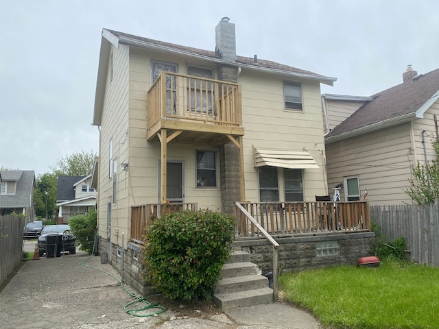 back of property featuring a balcony