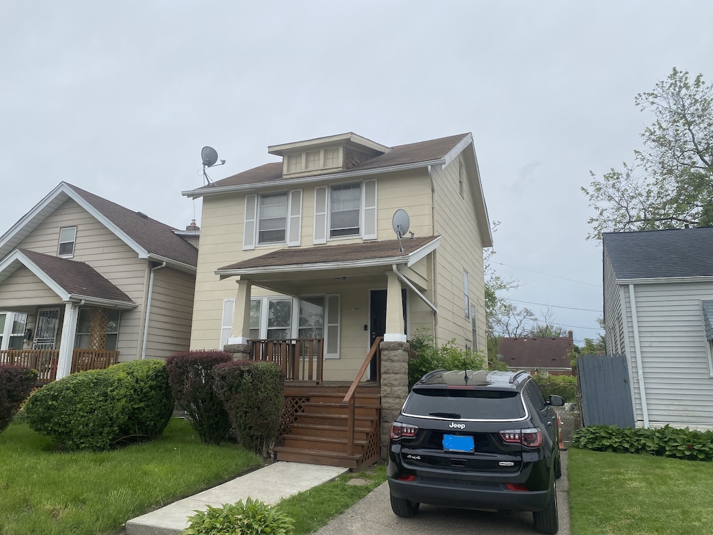 view of front of home featuring a front yard and a porch