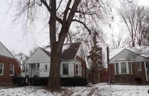 view of snowy exterior with a garage