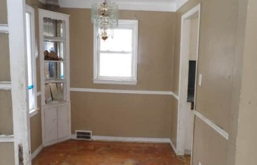 unfurnished dining area featuring a chandelier