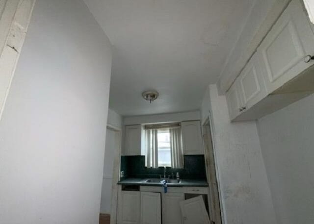 kitchen with white cabinetry and sink