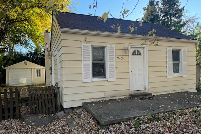 view of front facade with a storage shed