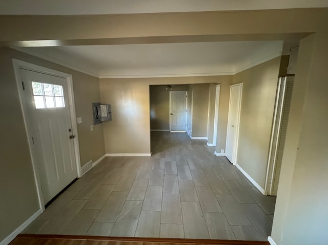 entryway with crown molding and light wood-type flooring