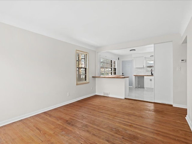 unfurnished living room featuring light wood-type flooring