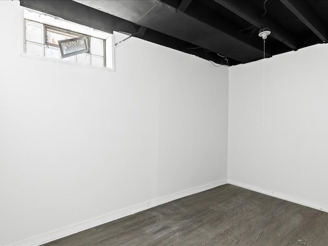 basement with dark hardwood / wood-style flooring