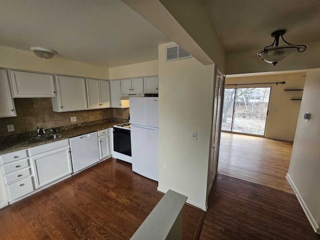 kitchen featuring sink, backsplash, white cabinets, and white appliances