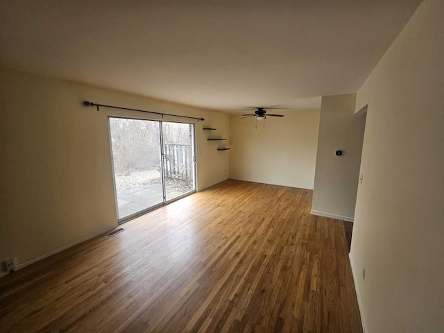 empty room with hardwood / wood-style floors and ceiling fan