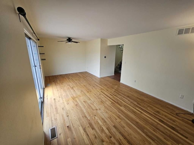 spare room with hardwood / wood-style flooring and ceiling fan