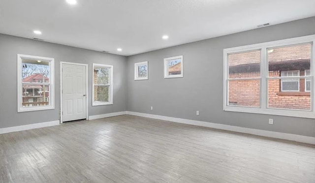 spare room featuring recessed lighting, light wood-type flooring, visible vents, and baseboards