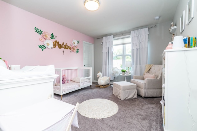 carpeted bedroom featuring a crib