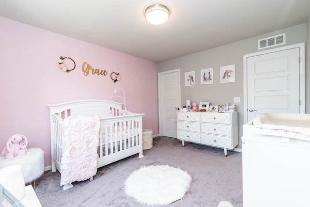 carpeted bedroom featuring a crib