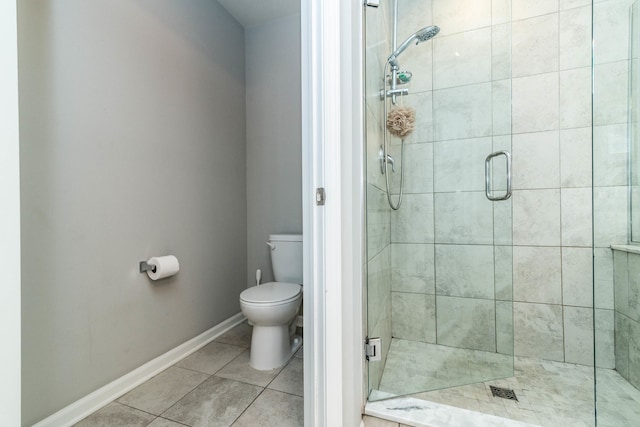 bathroom with tile patterned flooring, toilet, and walk in shower