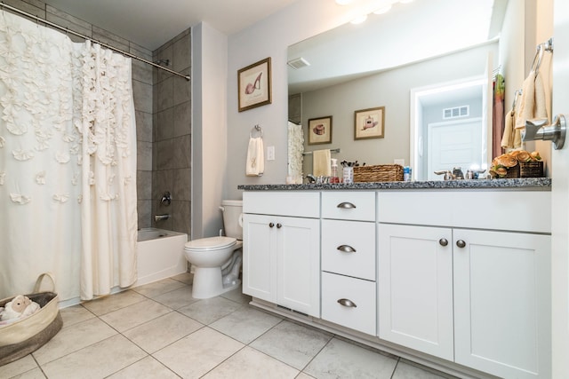 full bathroom with tile patterned floors, vanity, toilet, and shower / bath combo with shower curtain