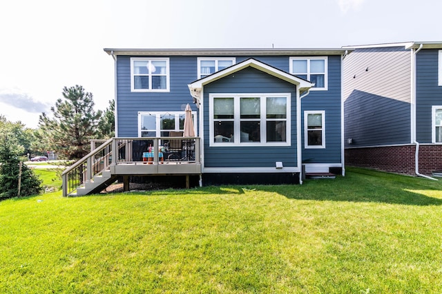 back of property with a wooden deck and a lawn