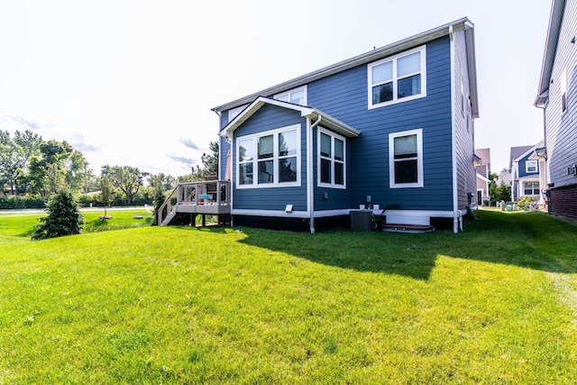 rear view of house featuring central AC, a lawn, and a deck