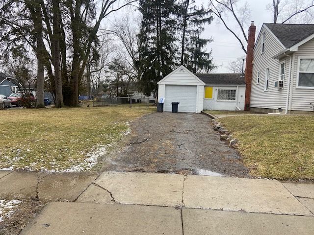 exterior space featuring cooling unit, a yard, and a garage