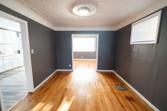 empty room with a textured ceiling and light wood-type flooring