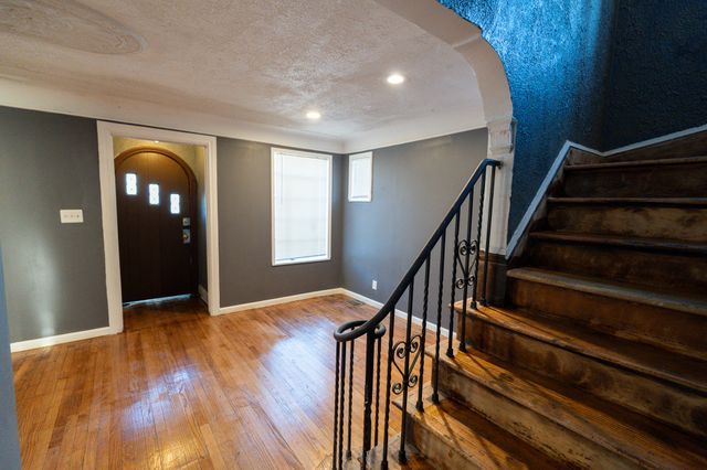 entrance foyer with hardwood / wood-style floors and a textured ceiling